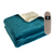 Neatly folded beautiful teal blue electric heated throw with controller